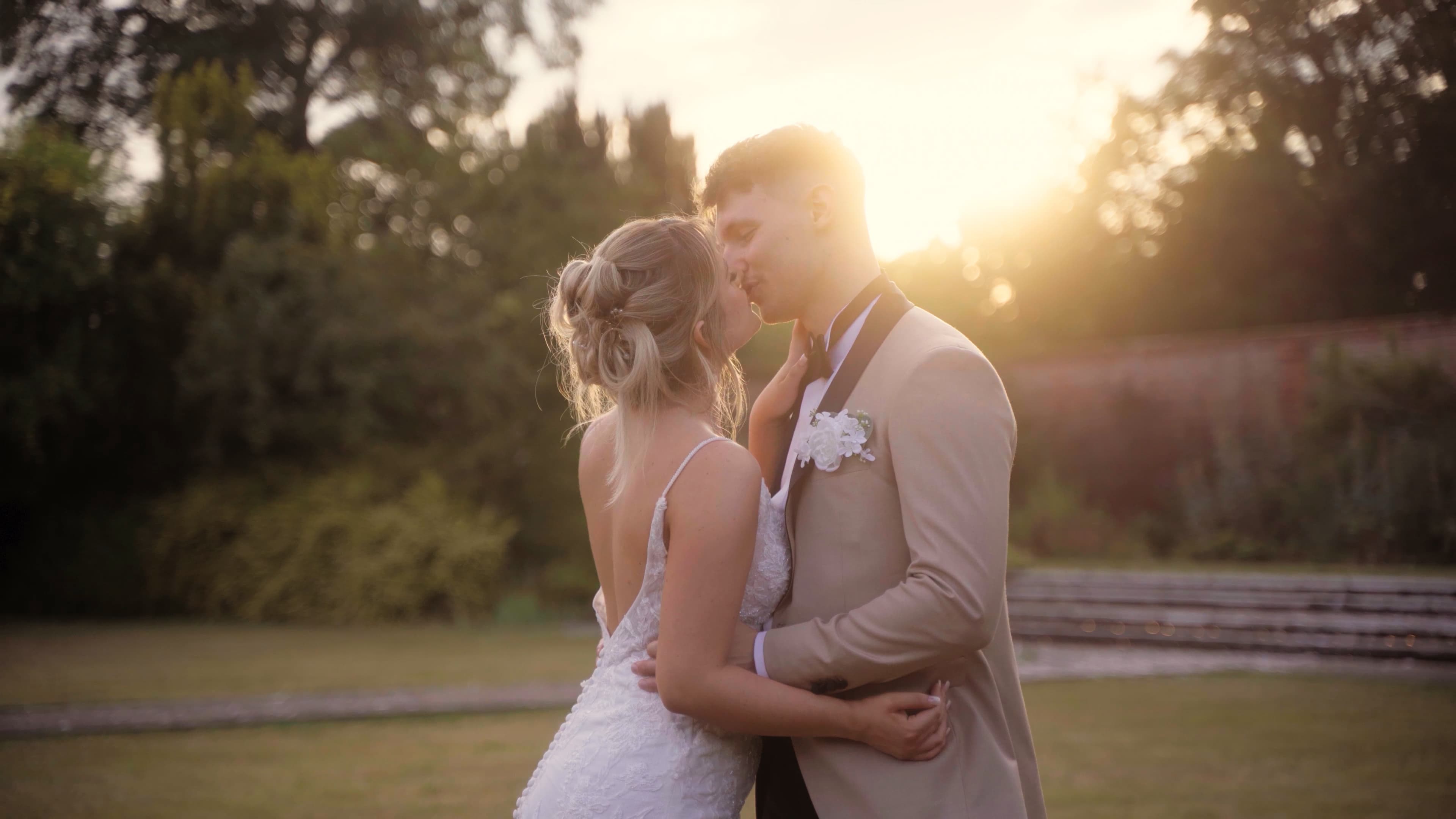 Neave and Ali dancing beneath festoon lights as night falls